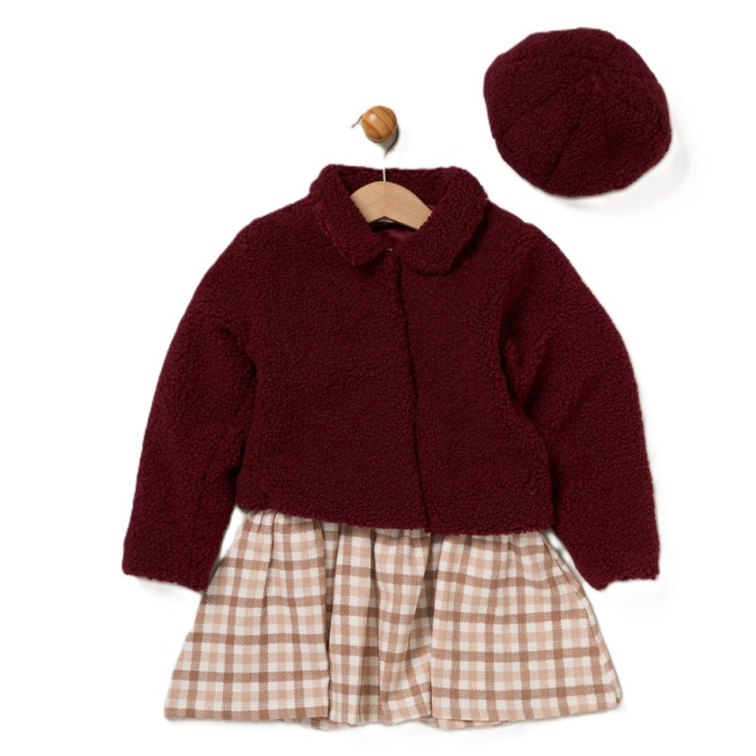A toddler girl's outfit set featuring a dark burgundy sherpa fleece cardigan, a matching burgundy beret, and a beige and brown plaid pleated skirt, displayed on a wooden hanger with a wooden peg against a white background.