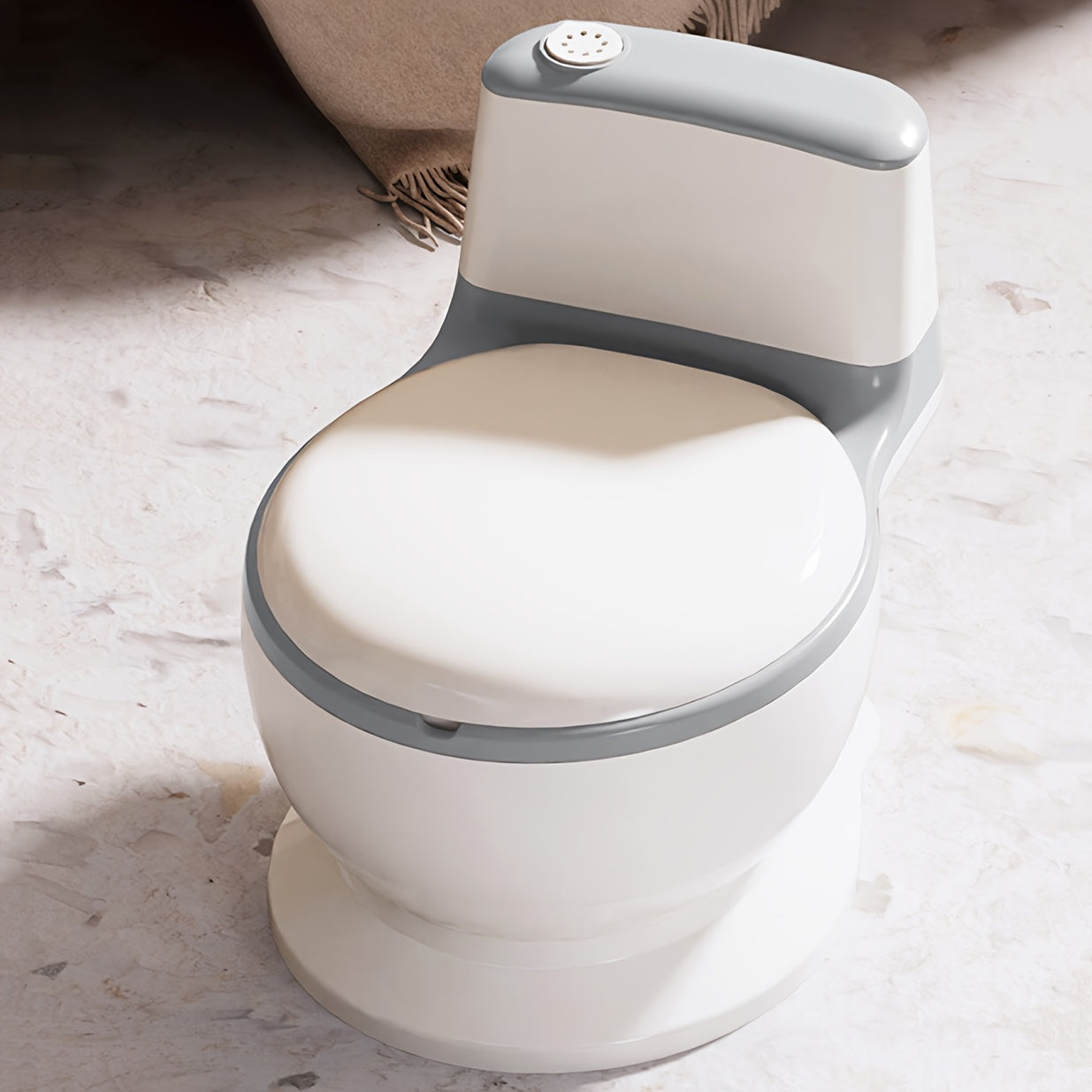 White and gray bidet toilet on a marble surface