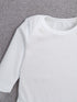 White long-sleeve shirt on a textured gray background