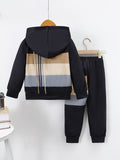 Children's black and beige tracksuit with striped back hanging on a white background