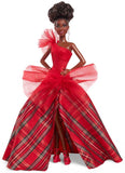 Barbie doll in a red plaid gown with a large bow on a white background