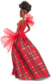 Barbie doll in a red and plaid dress with a white background