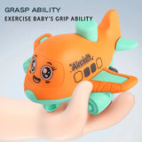 Orange airplane-shaped toy with a cartoon face held in a hand, on a light blue background.