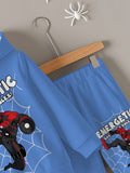 Blue children's outfit with superhero design on a hanger against a gray wall.