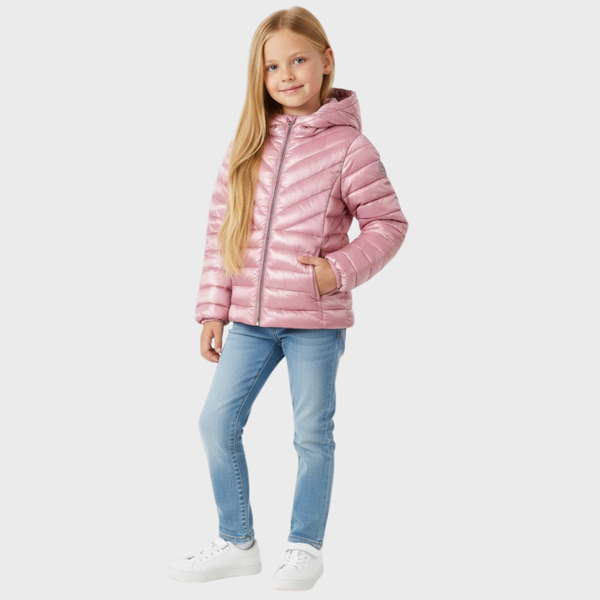 Young girl wearing a pink puffer jacket and light blue jeans on a white background