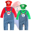 Two baby rompers with Mario and Luigi hats on a white background