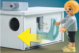 Playmobil figure interacting with a toy mailbox with a yellow arrow pointing to the slot.