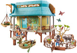 Toy playset with a wooden cabin, furniture, and figures on a white background