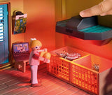 Toy figure interacting with a toy kitchen set in a playroom setting.