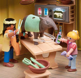 Playmobil toys with two characters and a creature in a room setting.