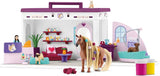 Toy dollhouse with furniture and a horse figure on a white background