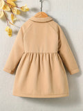 Beige coat on a hanger against a neutral background